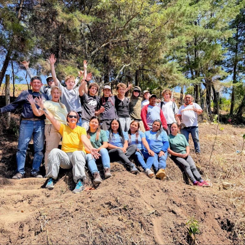 Mixed group posing outdoors, representing which Guatemala volunteer vacation is best humanitarian trip
