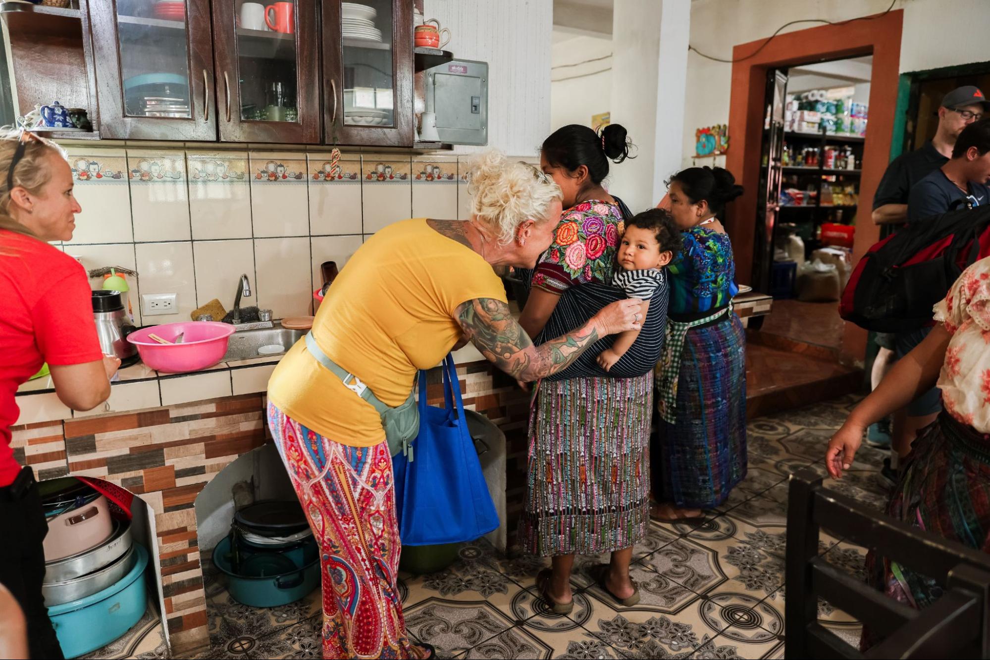 Volunteers on what Guatemala volunteer trips suit retirees, distributing supplies to local women in a classroom 