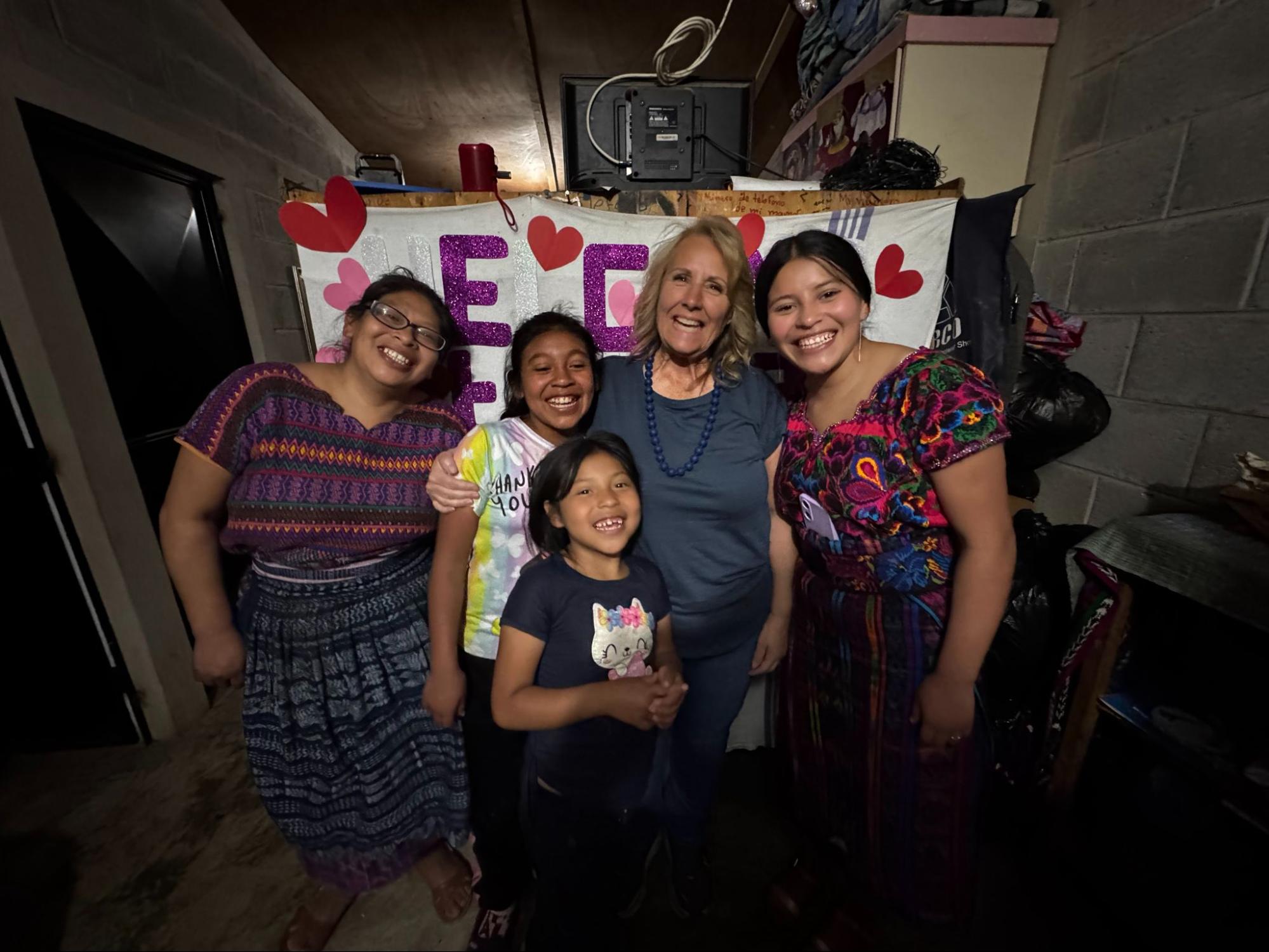A volunteer sharing a warm moment with a host family through the best Guatemala volunteer vacation programs for seniors.