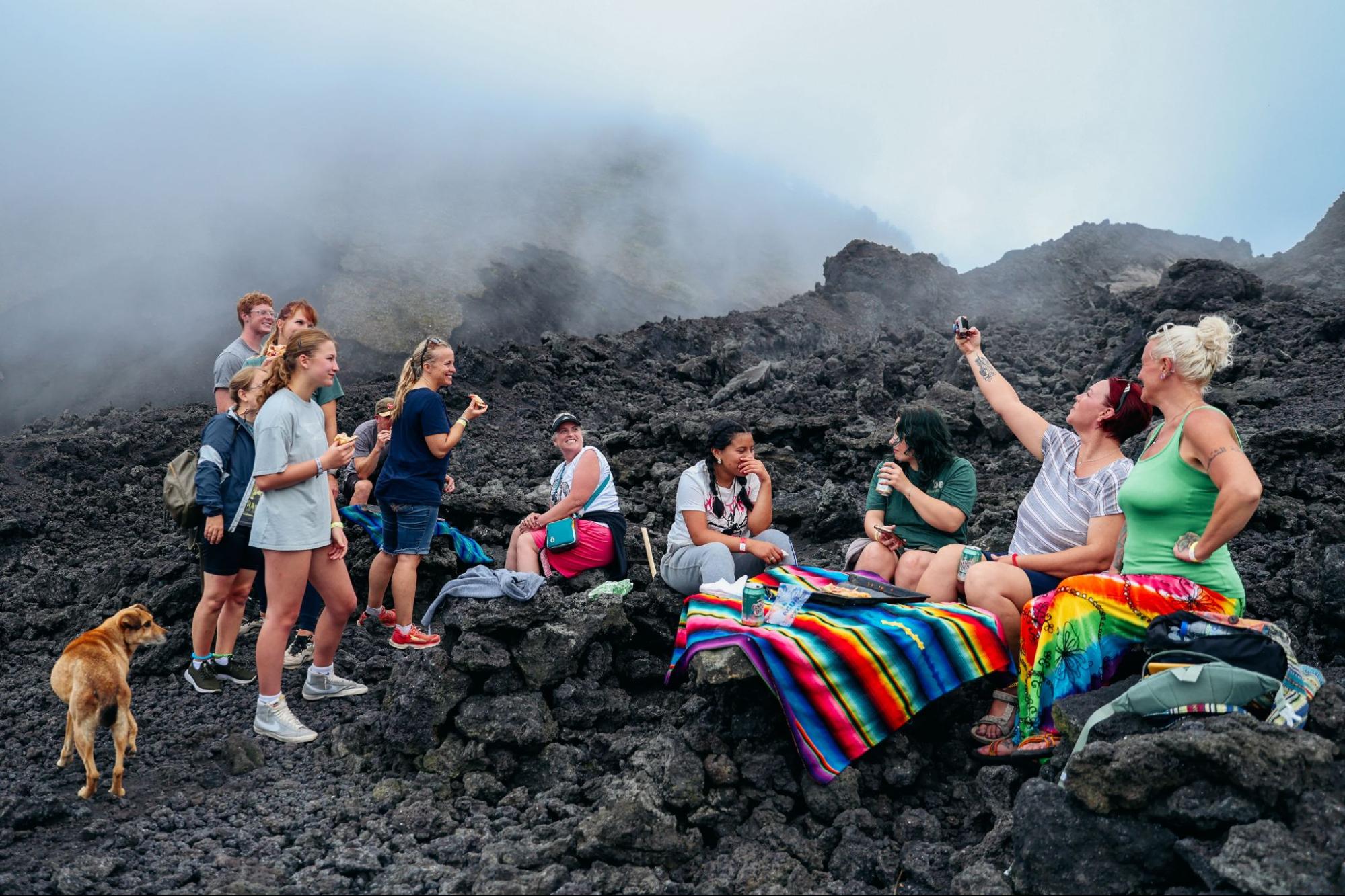 Volunteers resting on volcanic rocks during which Guatemala volunteer vacation is best adventure trip 