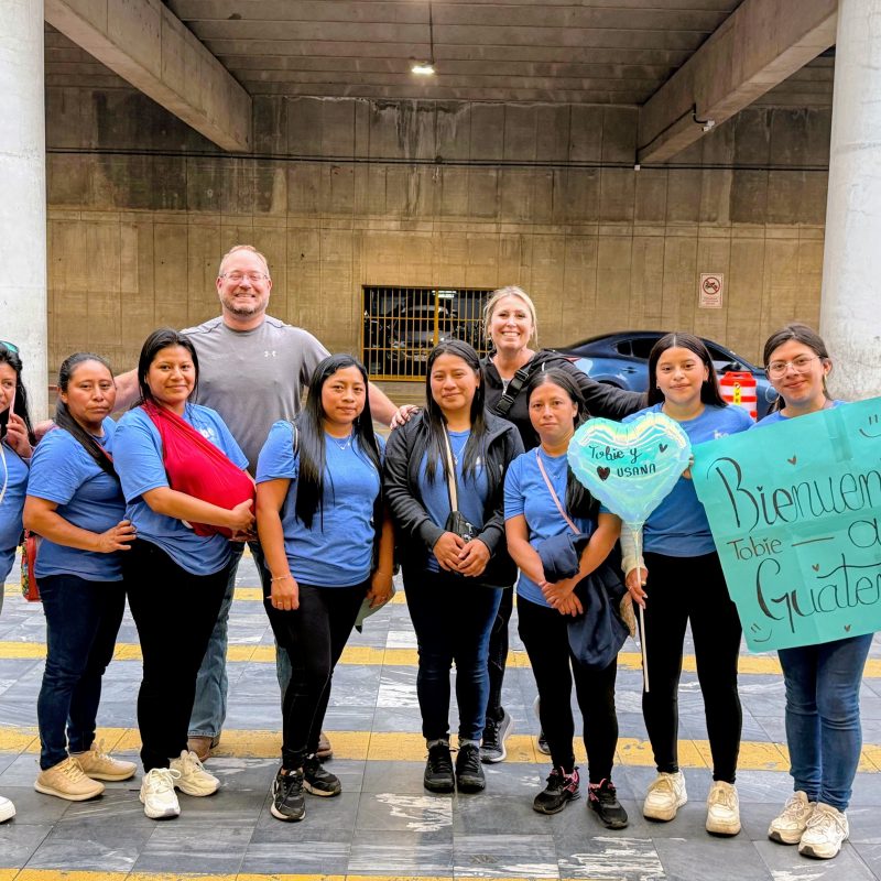 Group photo showing local customs etiquette Guatemala volunteers practice during a warm community welcome