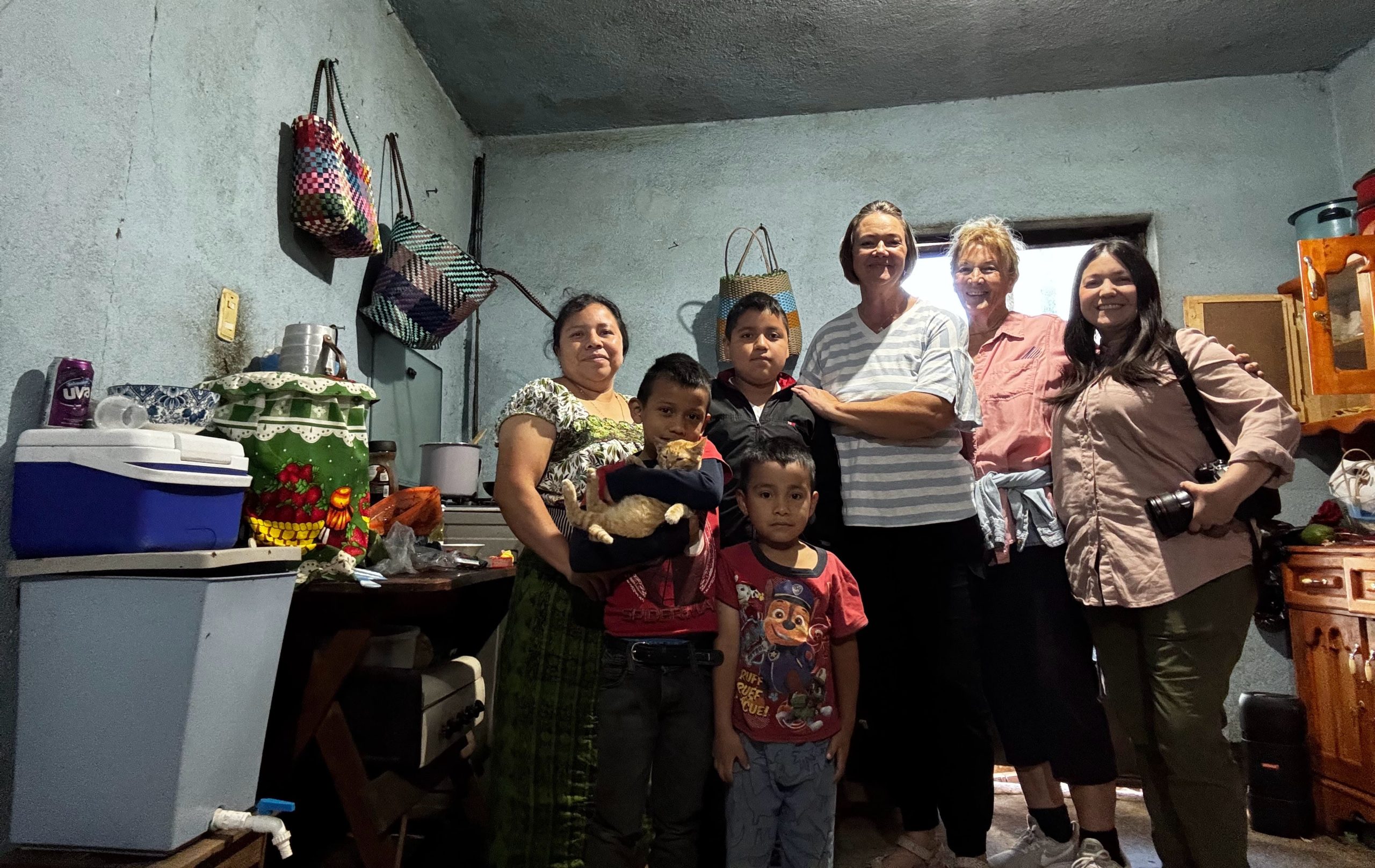 Volunteers inside a family home reflecting local customs etiquette Guatemala volunteers follow when visiting 