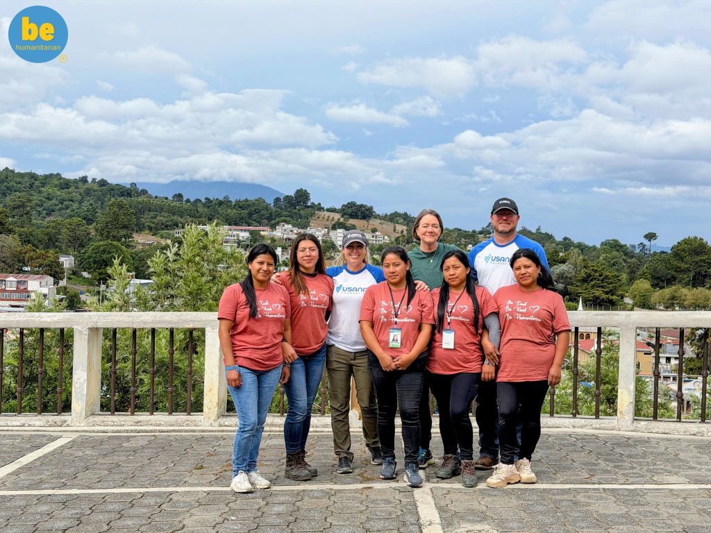 Volunteers and local women smiling together, showing how to combine child sponsorship and travel Guatemala