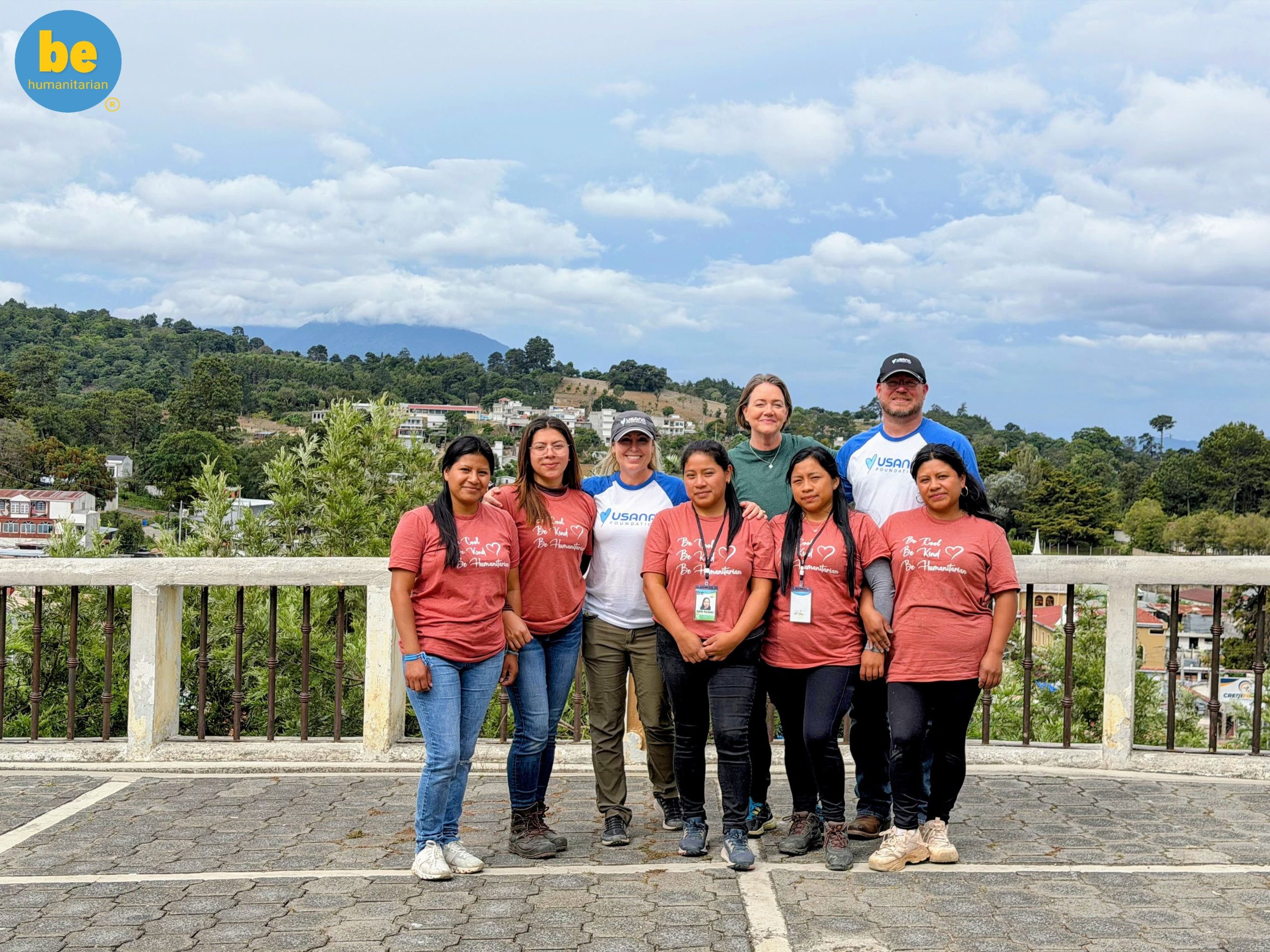 Volunteers and local women smiling together, showing how to combine child sponsorship and travel Guatemala