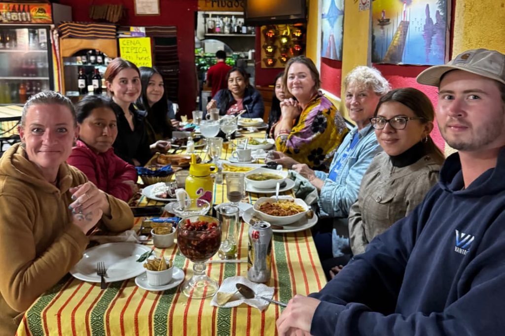 Volunteer group sharing a meal together on a fight malnutrition volunteer vacation Guatemala trip