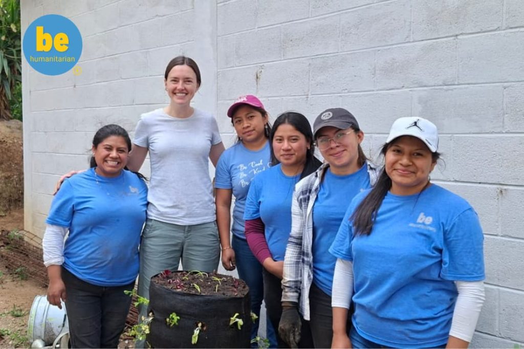 Volunteer team posing with a garden tower built to improve food security volunteer Guatemala families