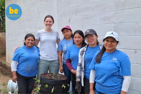 Volunteer team posing with a garden tower built to improve food security volunteer Guatemala families