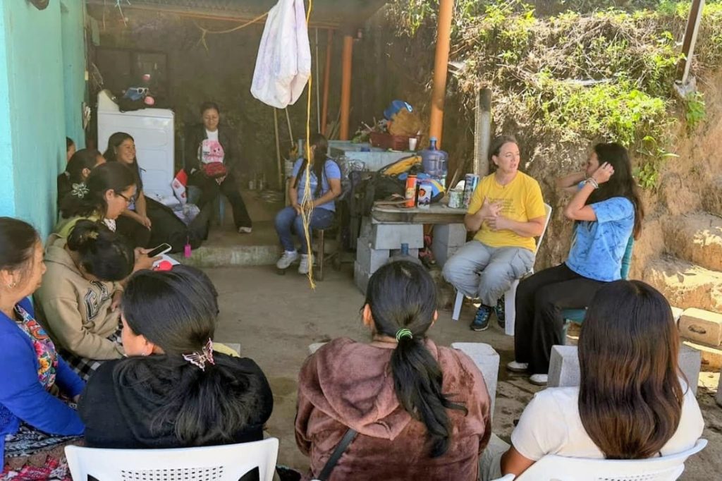 Volunteers leading a community meeting as part of rural poverty alleviation volunteer Guatemala efforts