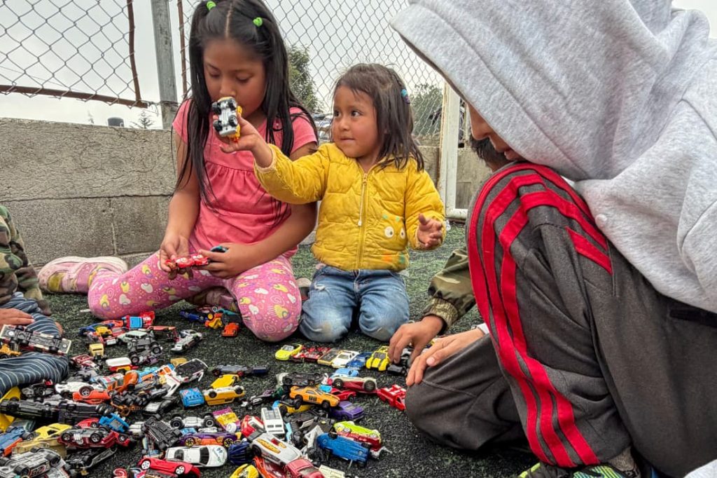 Children playing with toy cars together showing the emotional benefits sponsoring child Guatemala programs