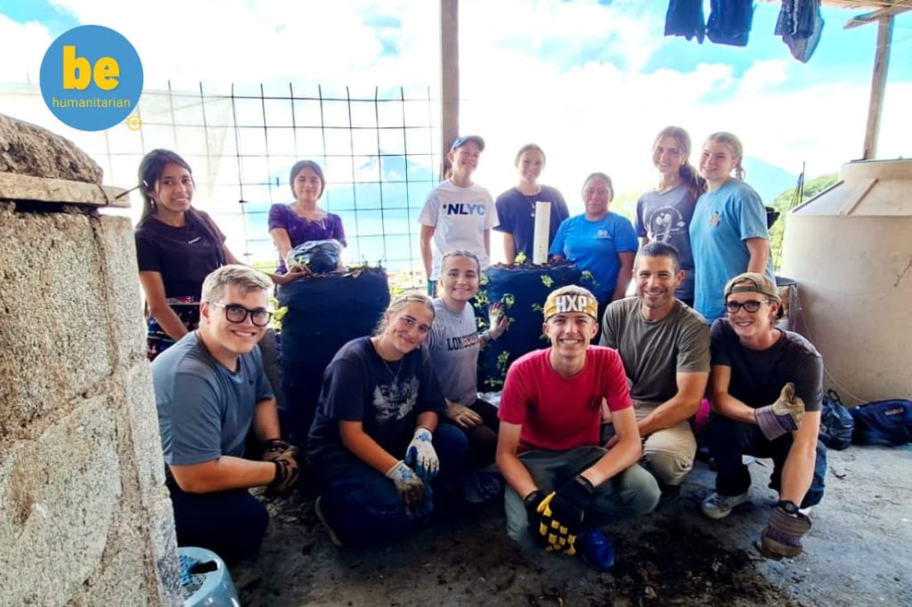 Volunteer team building garden towers together for 10 rural poverty alleviation volunteer Guatemala programs