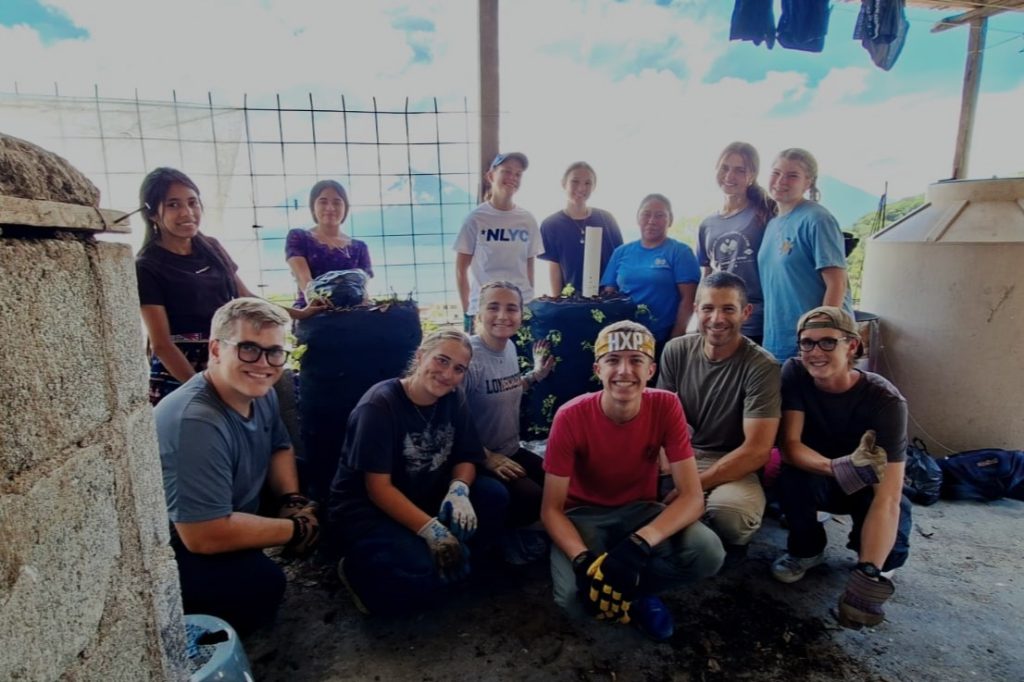 Volunteer group with local families shows why does guatemala volunteer impact matter in community projects 