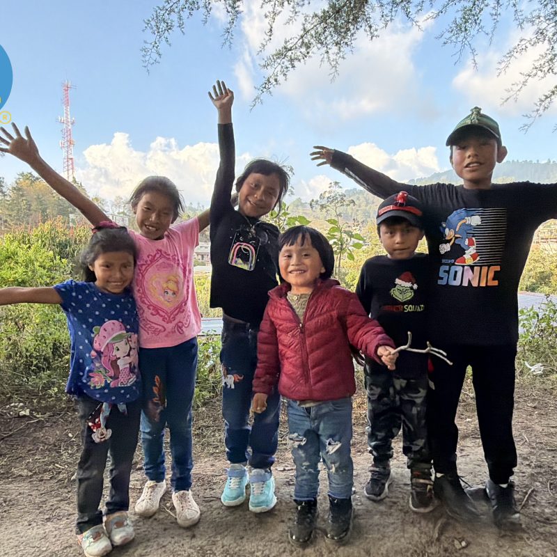 Smiling Guatemalan children outdoors show why does guatemala volunteer impact matter for their wellbeing