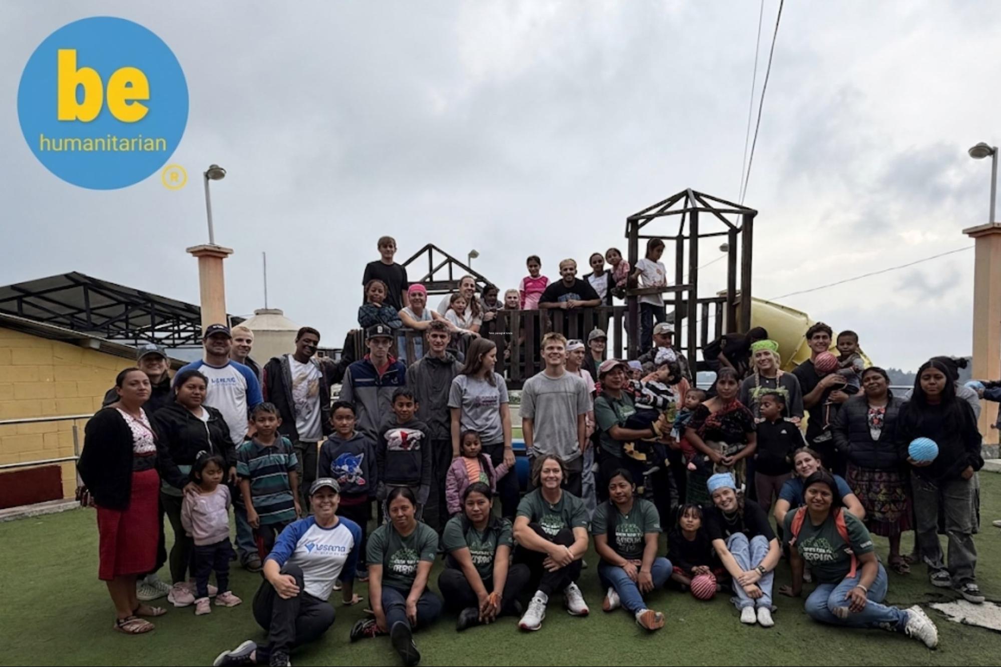 Volunteers and local community posing outdoors at a Guatemala playground, book ethical volunteer trips in guatemala