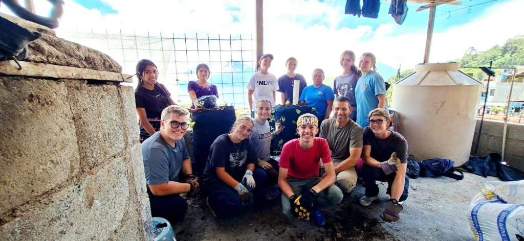 Volunteers and locals pose together after a service project, illustrating how volunteer vacations impact rural Guatemala. 