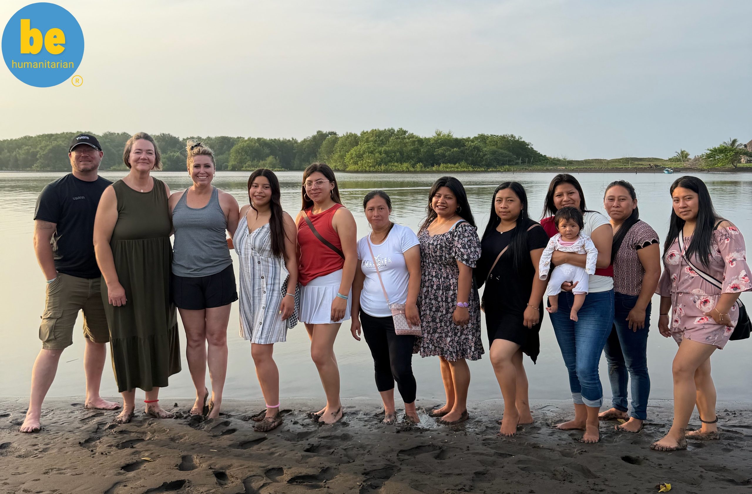 Learn how to plan a volunteer vacation Guatemala with local women by a river at sunset.